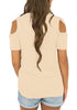 Back view of model wearing apricot crisscross cutout shoulder blouse