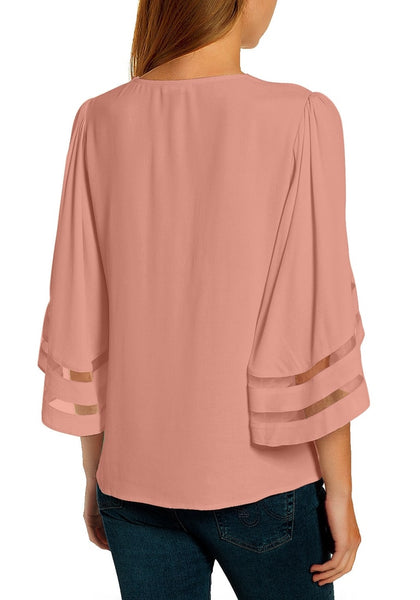 Back view of model wearing blush pink 34 bell mesh panel sleeves V-neckline loose top
