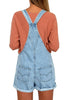 Back view of model wearing light blue rolled hem shorts denim bib overall