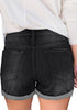 Back view of model wearing black roll-over hem ripped denim shorts
