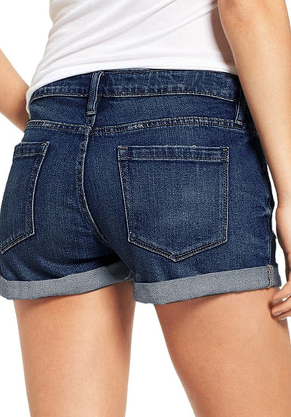 Back view of model wearing dark blue roll-over hem button-up distressed denim shorts