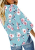 Back view of model wearing light blue V-neckline button-up tie-front floral top
