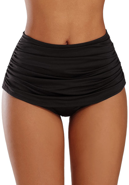 Front view of model wearing black high waist ruched swim bottom
