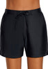 Front view of model wearing black lace-up board shorts