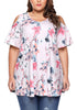 Front view of model wearing plus size light pink floral cold-shoulder blouse