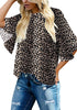 Front view of model wearing black trumpet sleeves keyhole-back leopard blouse