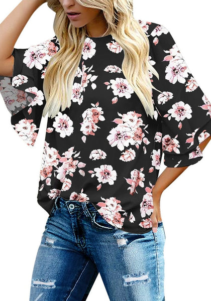 Front view of model wearing black trumpet sleeves keyhole-back printed blouse