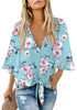 Front view of model wearing light blue V-neckline button-up tie-front floral top