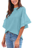 Front view of model wearing light blue trumpet sleeves keyhole-back blouse