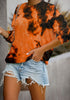 Model poses wearing orange tie-dye crewneck drop shoulder pullover sweater
