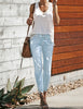 Whole body shot of model wearing light blue split-hem ripped skinny denim jeans