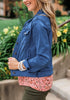 Side view of model wearing deep blue button down women's denim jacket