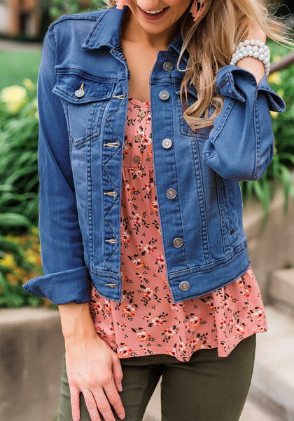 Model poses wearing deep blue button down women's denim jacket