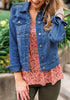 Model poses wearing deep blue button down women's denim jacket