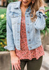 Model poses wearing light blue button down women's denim jacket