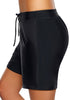 Side view of model wearing black lace-up board shorts
