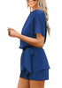 Side view of model wearing blue short sleeves keyhole-back belted romper