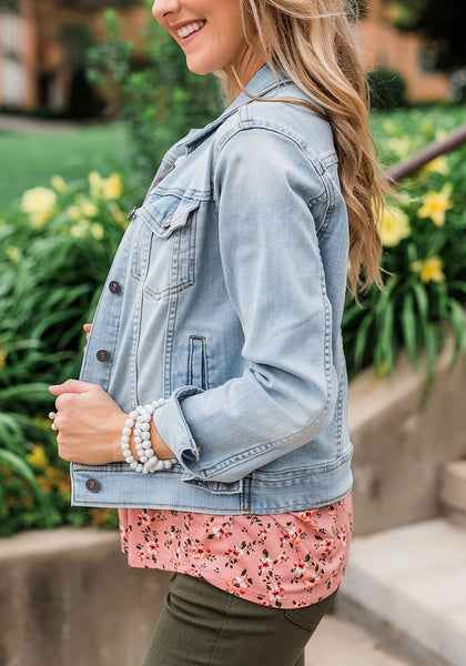 Side view of model wearing light blue button down women's denim jacket