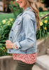 Side view of model wearing light blue button down women's denim jacket