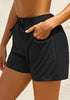 Side view of model wearing black elastic-waist side pockets lace-up board shorts