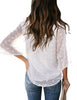 Back view of model wearing white swiss dot 3/4 sleeves tie-front button down top
