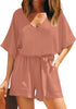 Model wearing blush V-neckline keyhole-back loose belted romper