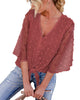 Model poses wearing blush 3/4 sleeves pompom tie-front top