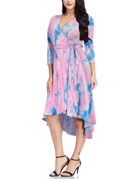 Frontal view of model in pink tie-dye high-low plus size wrap skater dress