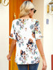 Back view of model wearing white ruffle trim short sleeves floral-print V-neck button-down top