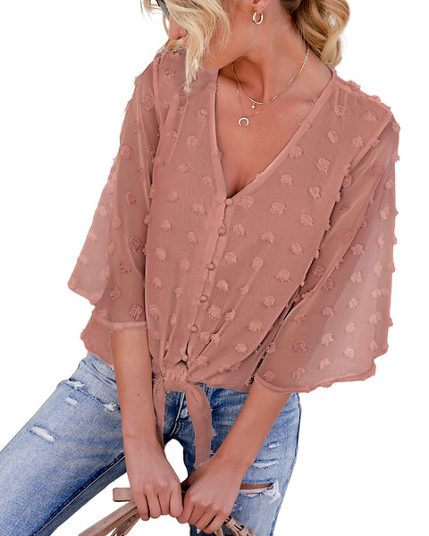 Model poses wearing mauve 3/4 sleeves pompom tie-front top