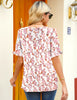 Back view of model wearing light pink ruffle trim short sleeves printed v-neck button-down top
