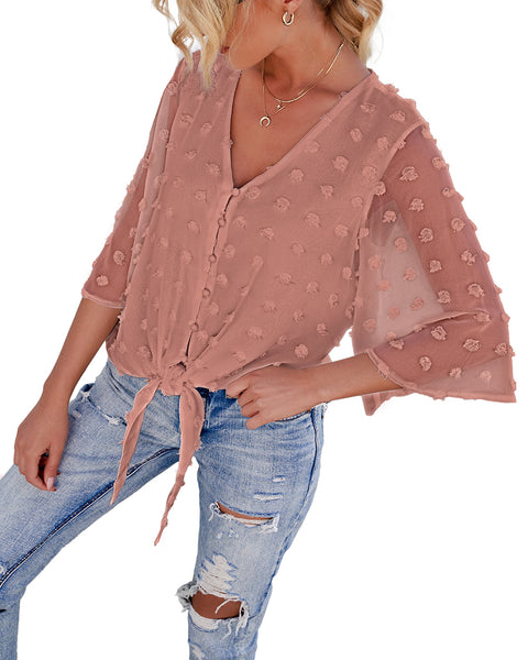 Angled view of model wearing mauve 3/4 sleeves pompom tie-front top