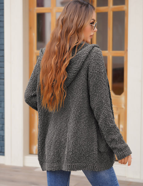 Back view of model wearing dark grey button down melange waffle knit hooded cardigan