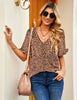 Front view of model wearing deep brown trim short sleeves printed V-neck button-down top