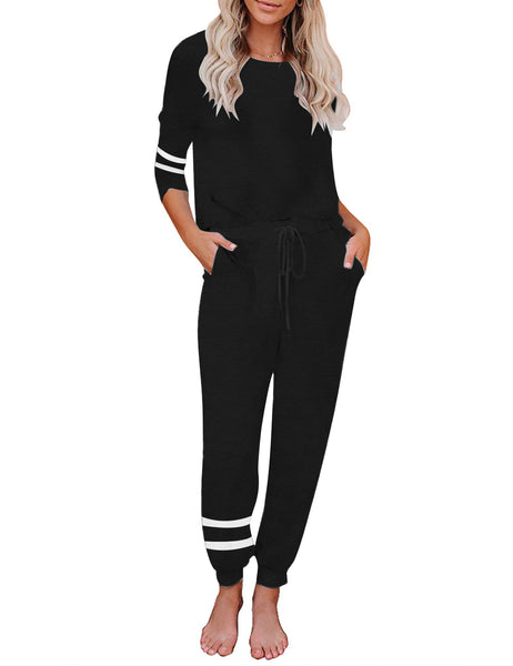 Front view of model wearing black stripe drawstring-waist jogger pajama set