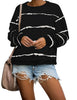 Posing model wearing black striped drop shoulder pullover sweater