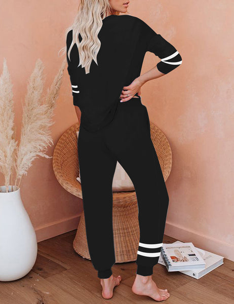 Back view of model wearing black stripe drawstring-waist jogger pajama set