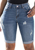 Front view of model wearing light blue mid-waist cuffed hem distressed denim bermuda shorts