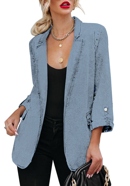 Model wearing light blue lapel collar flap pockets open-front denim blazer