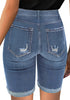 Back view of model wearing light blue mid-waist cuffed hem distressed denim bermuda shorts