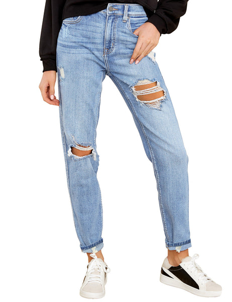 Model poses wearing blue cuffed ripped denim boyfriend jeans