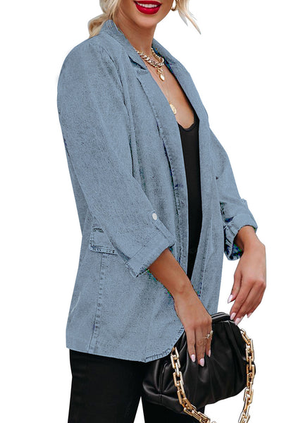 Side view of model wearing light blue lapel collar flap pockets open-front denim blazer