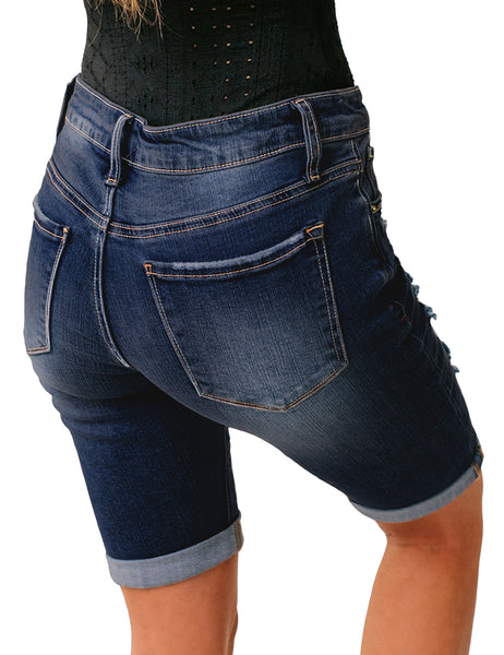 Back view of model wearing dark blue women mid-waist frayed bermuda denim shorts