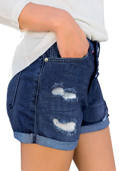 Side view of model wearing deep blue roll-over hem button-up ripped denim shorts