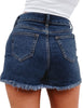 Back view of model wearing dark blue high-waist frayed raw hem ripped denim shorts