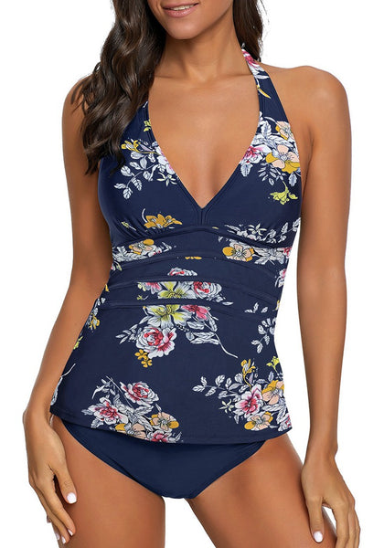 Front view of model wearing navy floral halter V-neck tankini set.