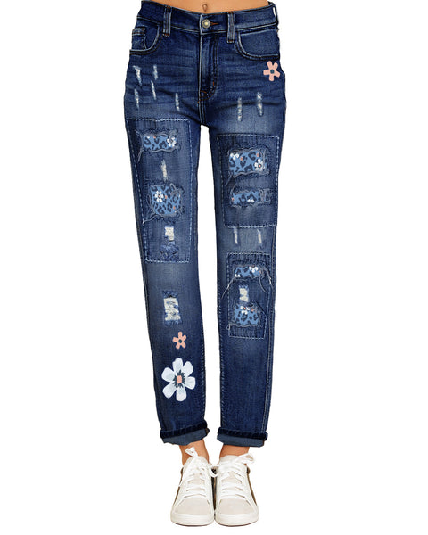 Front view of model wearing blue floral-print patch ripped rolled hem denim boyfriend jeans