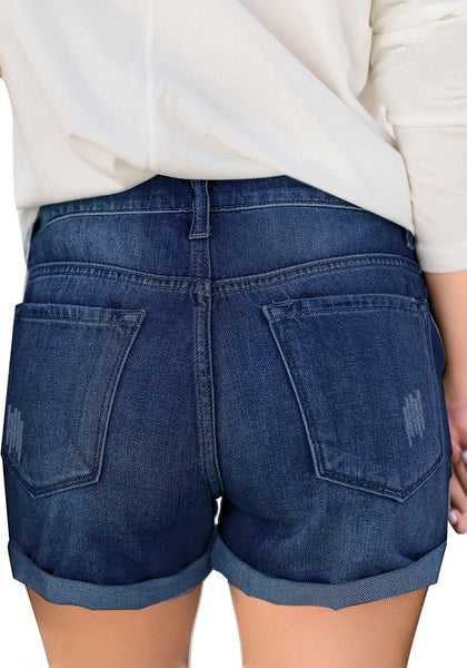 Back view of model wearing deep blue roll-over hem button-up ripped denim shorts