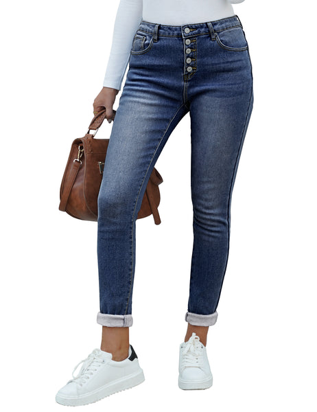 Angled view of model wearing dark blue fleece-lined button-down denim skinny jeans