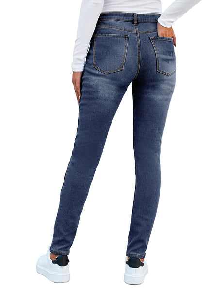 Back view of model wearing blue mid-waist skinny fit denim jeans